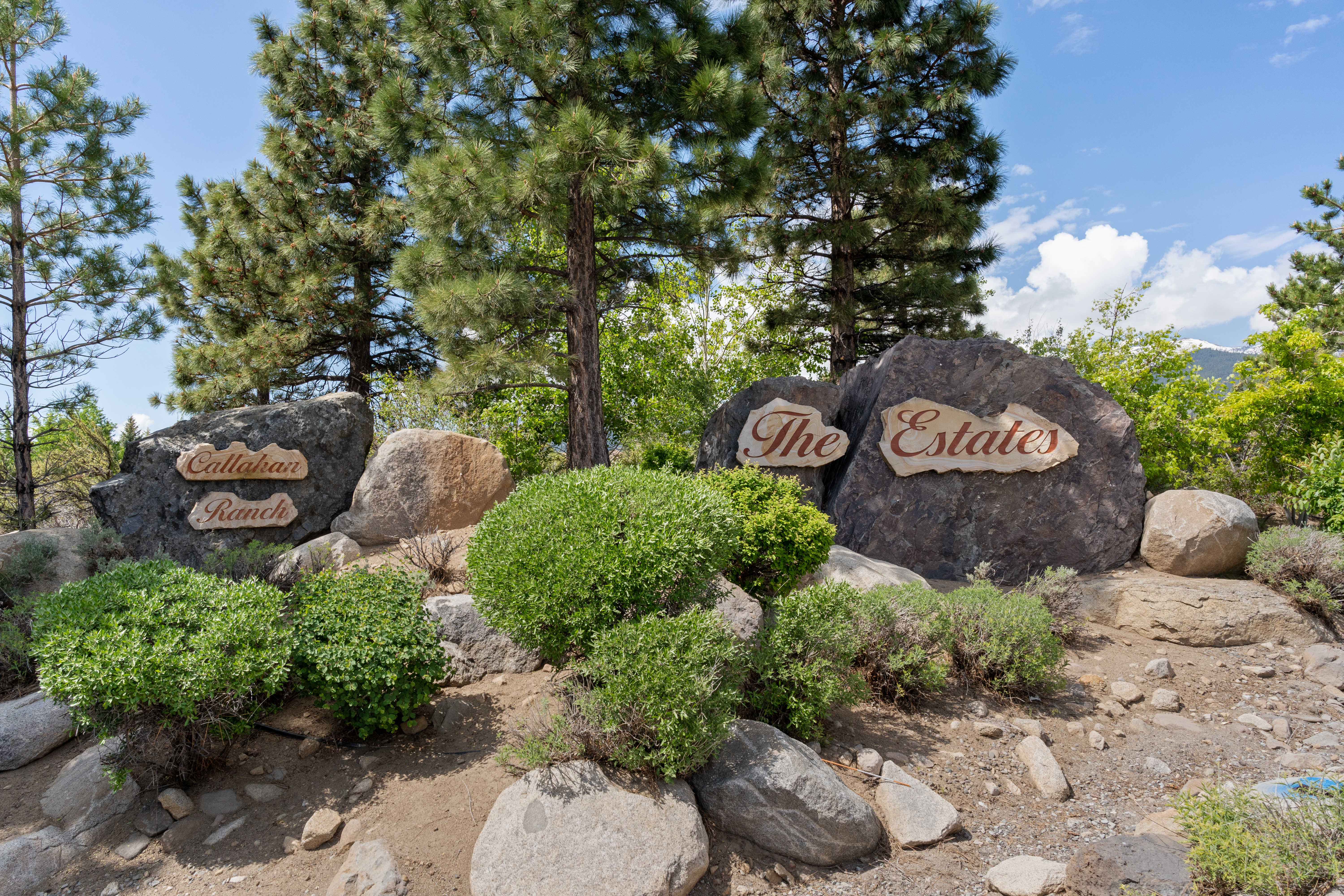 The Estates sign with pine trees